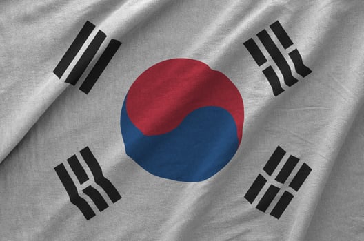 South Korea flag depicted on folded wavy fabric of old cloth photo