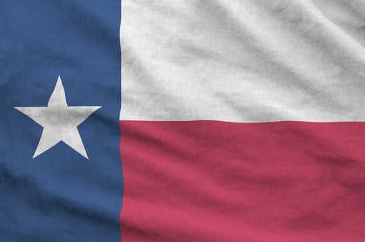 Texas US state flag depicted on folded wavy fabric of old cloth photo
