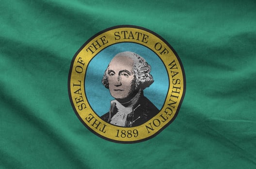 Washington US state flag depicted on folded wavy fabric of old cloth photo