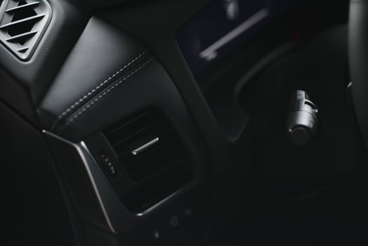 Luxury car interior. Steering wheel, shift lever and dashboard. photo