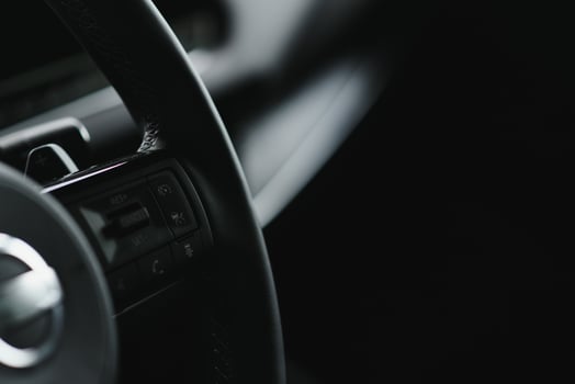 Luxury car interior. Steering wheel, shift lever and dashboard. photo