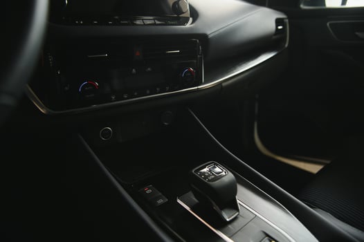 Luxury car interior. Steering wheel, shift lever and dashboard. photo