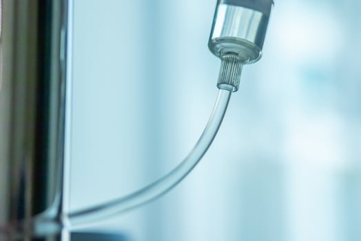 Close up medical intravenous IV drip in hospital background photo