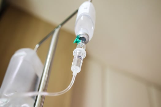Close up medical intravenous IV drip in hospital background photo