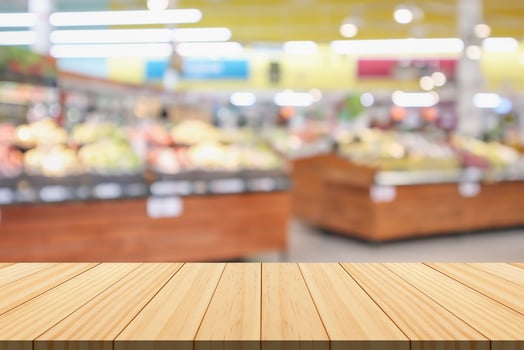 Empty wood table top with supermarket blurred background for product display photo