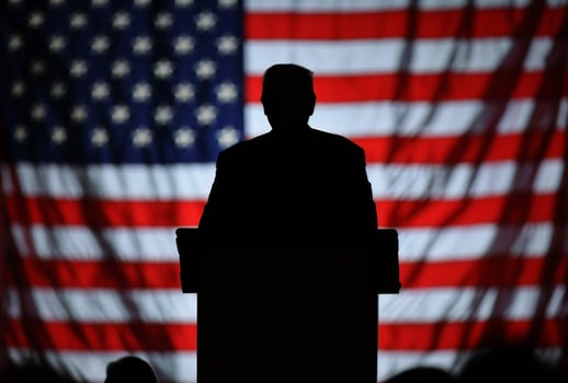 Silhouette of a person at a podium with USA flag background. photo