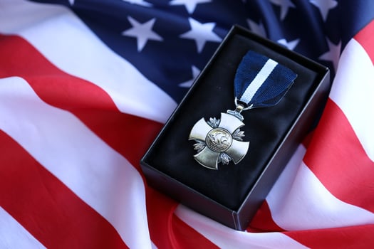 KYIV, UKRAINE - JULY 10, 2024 US Navy Cross medal. United States military award medal with ribbon and pin. Handmade paper theater props photo