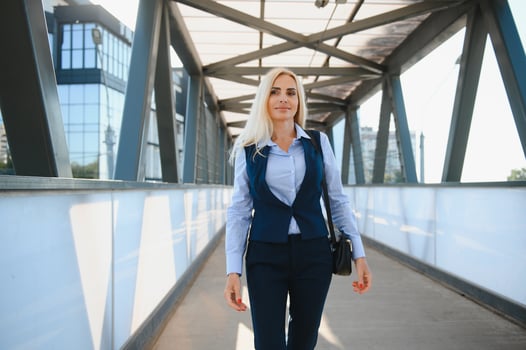 Close up portrait of a serious business woman in blue suit standing in the city photo