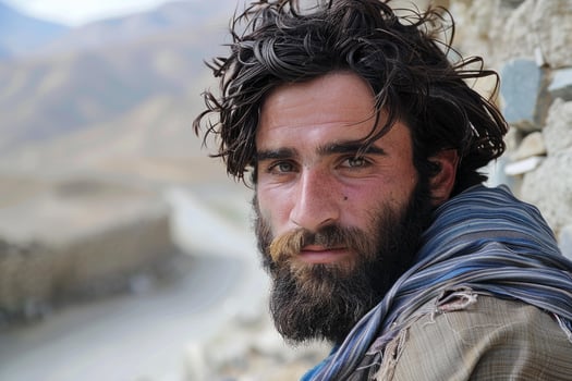 Portrait of a bearded man in a mountainous landscape photo