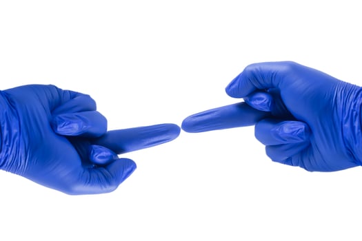 Two blue gloved hands pointing to each other with middle finger on white background. copy space photo