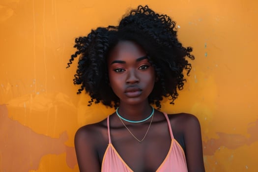 Beautiful black woman posing against yellow wall photo