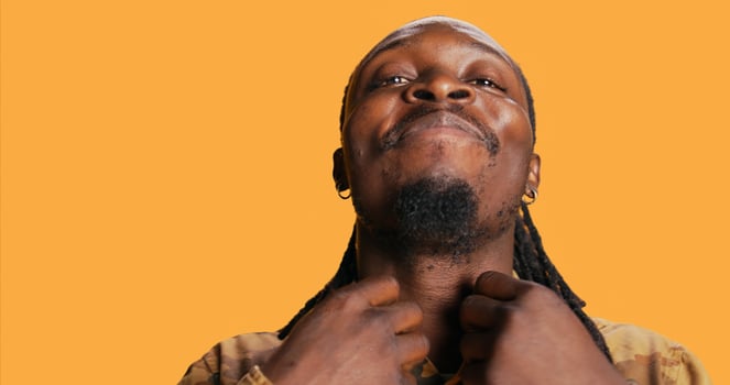 POV of african american guy looks at his reflection in the mirror, arranging his beard and dreads to be confident and trendy. Modern adult is looking at himself and feeling good. Tripod shot. photo