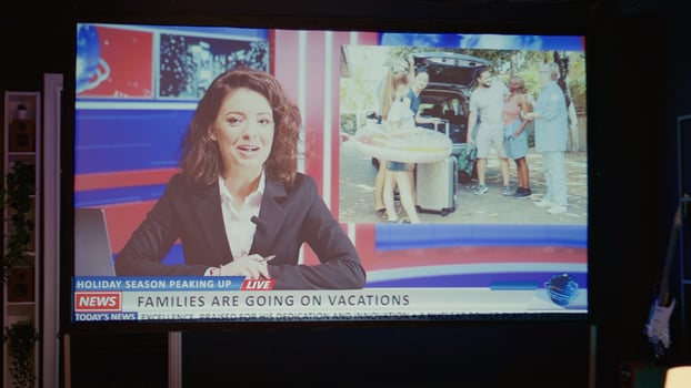 News reporter covering different subjects on VOD streaming service channel. Zoom out shot of smart TV in empty dimly lit apartment living room showing journalist talk about reportages photo