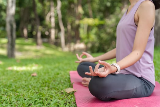 Woman Practicing Yoga Outdoors on Grass in Park, Meditating in Nature, Healthy Lifestyle, Relaxation and Mindfulness photo