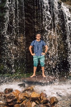 Man at waterfall in summer Altai photo