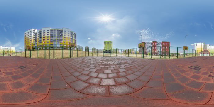 360 hdri panorama on sports or childrens playground in middle of residential complex among skyscrapers buildings with outdoor exercise equipment gym in equirectangular projection. landscaping concept photo