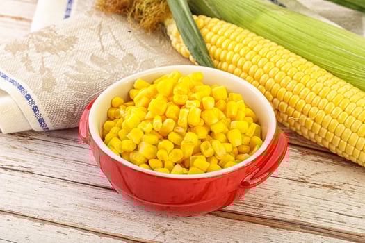 Canned yellow corn in the bowl photo