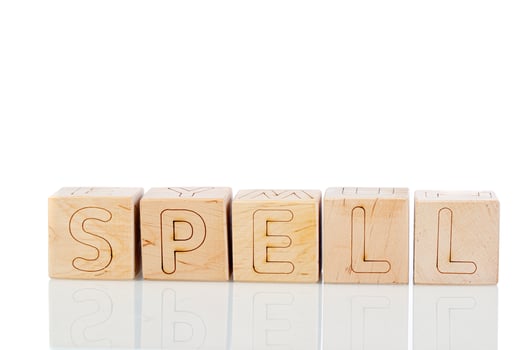 Wooden cubes with letters spell on a white background photo