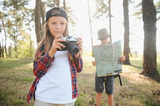 Girl scout frying marshmallows on fire at the woods. photo