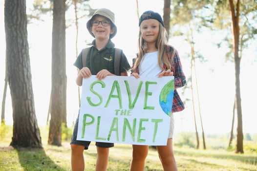 Children are holding a poster Save the planet. photo