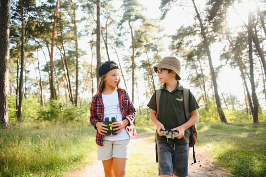 kids in green forest playing,concept of kids vacations and travel photo