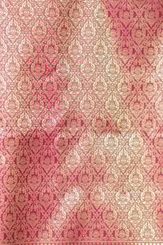 Thai silk with beautiful patterns and a high price because silk is added using ancient methods to produce fibers and weaving with ancient weaving machines resulting in beautiful patterned silk. photo