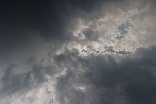 Black clouds in the sky in the rainy season are the formations of a rain storm in the evening. The background of the sky full of black dark rain clouds photo