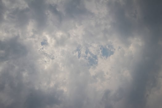 Black clouds in the sky in the rainy season are the formations of a rain storm in the evening. The background of the sky full of black dark rain clouds photo