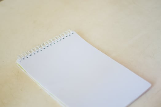 blank notebook on white table, business concept photo