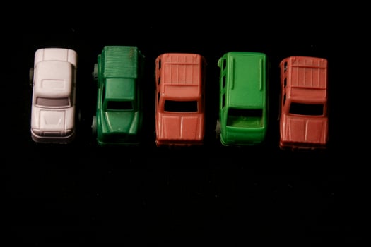 Miniature plastic toy car on a black background photo
