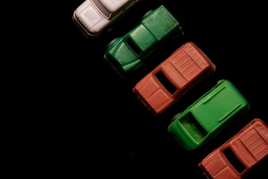 Miniature plastic toy car on a black background photo