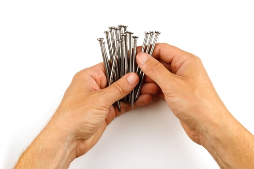 Hands holding nails. Construction nails in hand isolate. photo