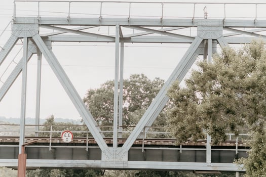 Metal Railway Bridge Structure Against Sky photo