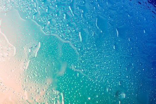 Water drops on glass, blue beige gradient. Concept of sea of relaxation. Abstract summer background photo