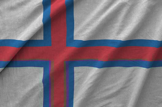 Faroe islands flag depicted on folded wavy fabric of old cloth photo