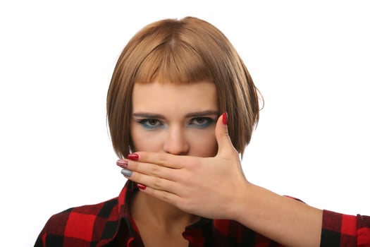 Woman covers her mouth with hand. Freedom of speech concept. Body language. Isolated on a white background photo