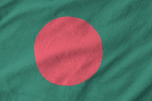 Bangladesh flag depicted on folded wavy fabric of old cloth photo