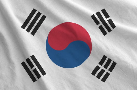 South Korea flag depicted on folded wavy fabric of old cloth photo