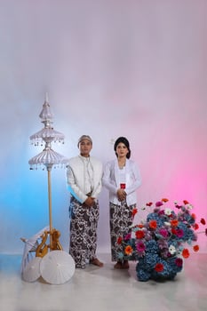 A pair of elegant Asian men and women wearing modern Javanese traditional clothing, white velvet bridal kebaya, pre-wedding concept on a white studio background. for advertising content, fashion photo