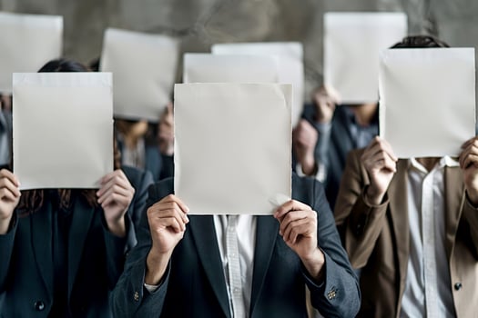 business man holding up an empty sheet of paper with a question mark symbol photo