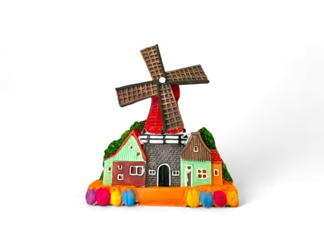 Miniature house decoration with a windmill on a white background photo