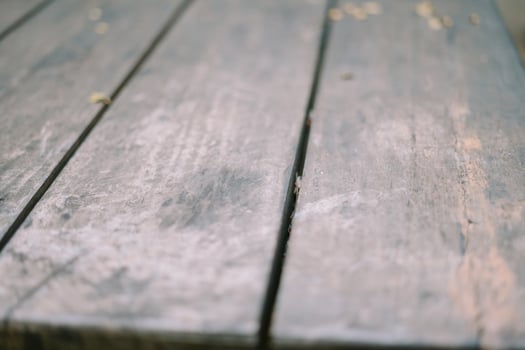A weathered yet sturdy wooden table structure displays a blend of rustic charm and durability photo