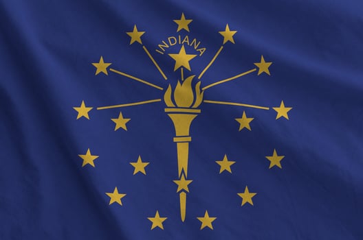 Indiana US state flag depicted on folded wavy fabric of old cloth photo