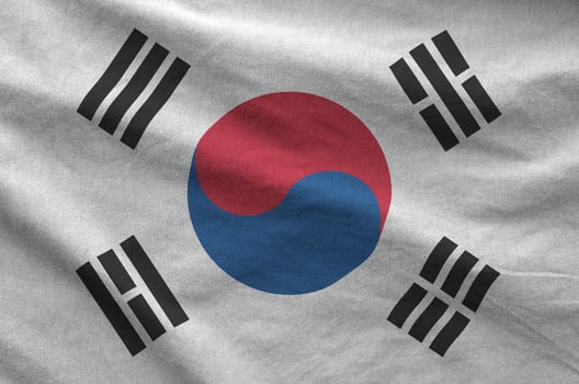 South Korea flag depicted on folded wavy fabric of old cloth photo