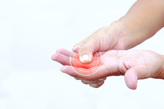 Focus of woman finger suffering from knuckle pain on white background. Healthcare and office syndrome concept. photo