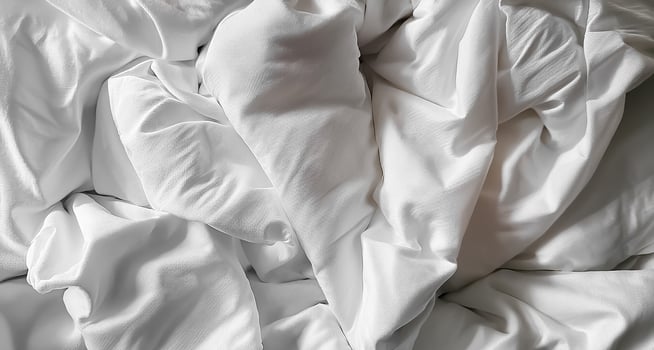 Background concept. Soft bed sheets that are still wrinkled after being used. The white bed sheets were crumpled and shabby. Pattern texture background. photo