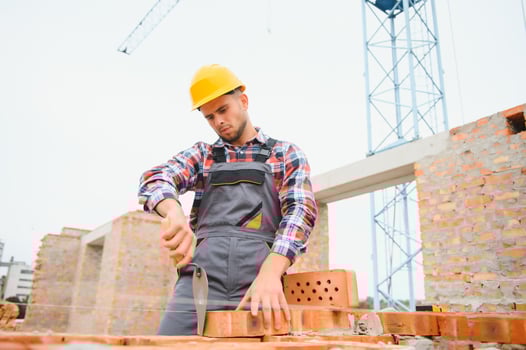 Construction worker in uniform and safety equipment have job on building photo