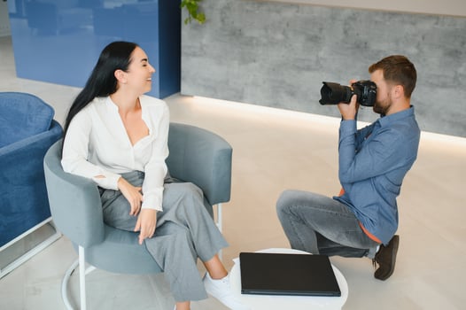 Male photographer taking picture of young woman photo