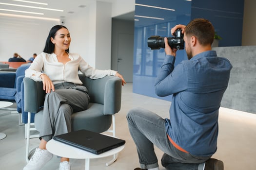 Male photographer taking picture of young woman photo