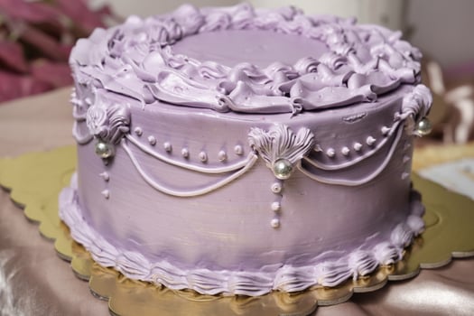 a purple cake with pearls and ruffles on top photo